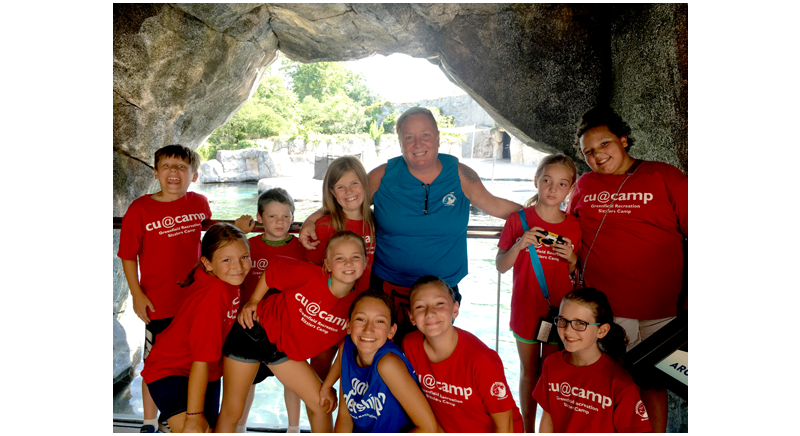 summer camp kids with their counselor on a cave fieldtrip